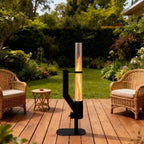 Outdoor patio heater on a wooden deck with chairs and a small table in a garden setting.