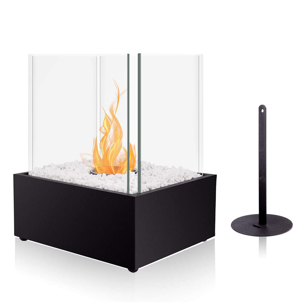 Modern indoor fireplace with glass front and black base on a white background