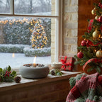 Cosy Christmas scene with a decorated tree, Gaia fire pit, and snowy outdoor view.
