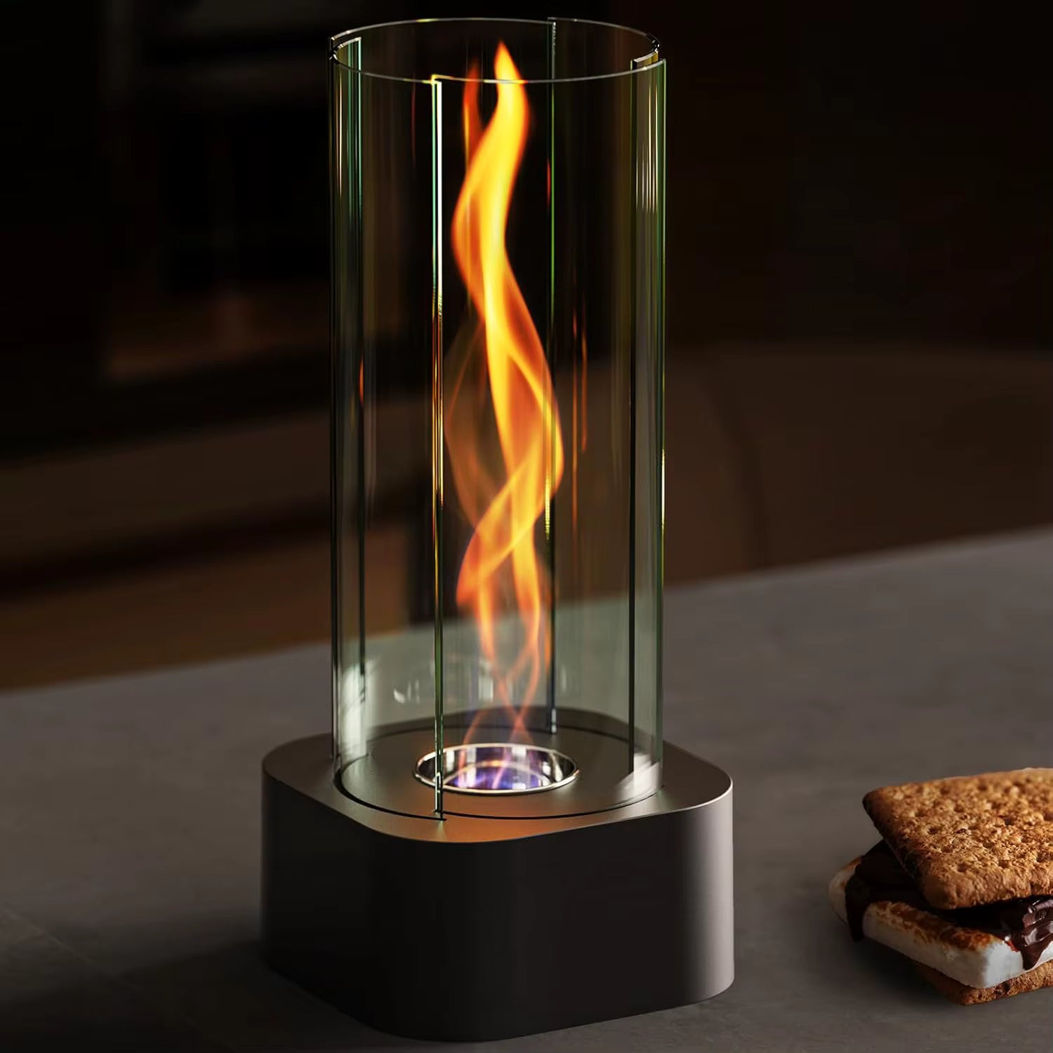 Hestia Tabletop fire pit with flames inside a glass container on a dark surface.